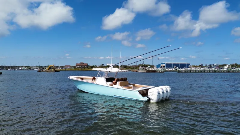 Slide: The Image of 2021 Valhalla Boatworks V-41 on water, clear sky, marina background. - 11