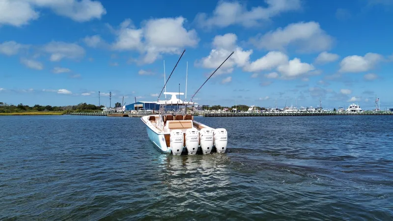 Slide: The Image of 2021 Valhalla Boatworks V-41 with four engines on open water under blue sky. - 12