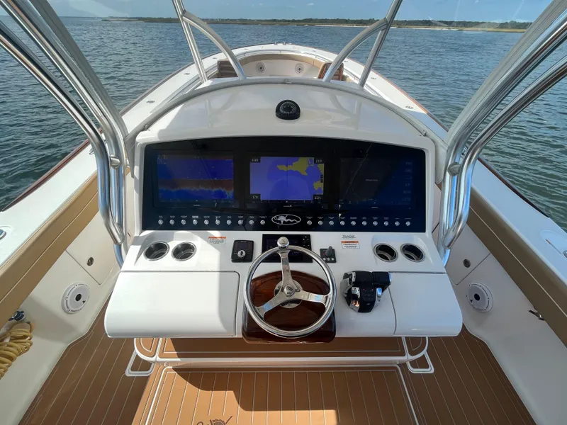 Slide: The Image of 2021 Valhalla Boatworks V-41 helm with advanced navigation displays on open water. - 15