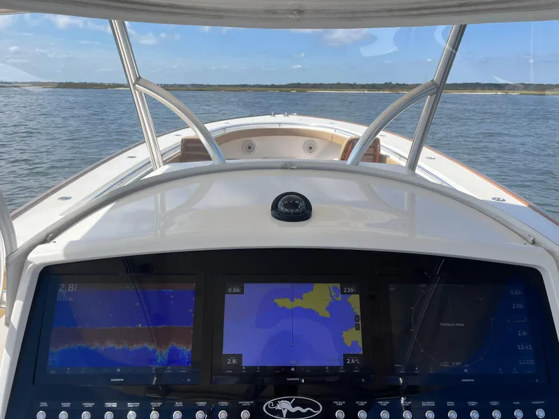 Slide: The Image of 2021 Valhalla Boatworks V-41 dashboard with navigation screens on open water. - 18