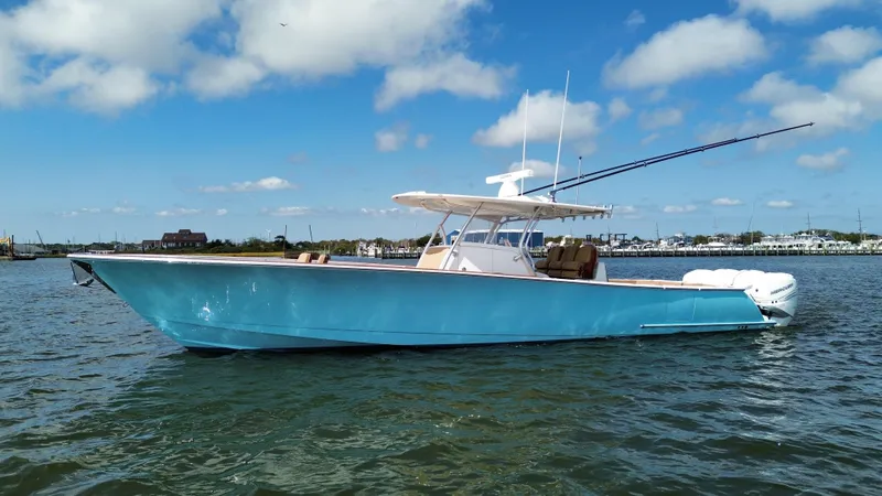 Slide: The Image of 2021 Valhalla Boatworks V-41 in blue on calm water under a clear sky. - 4
