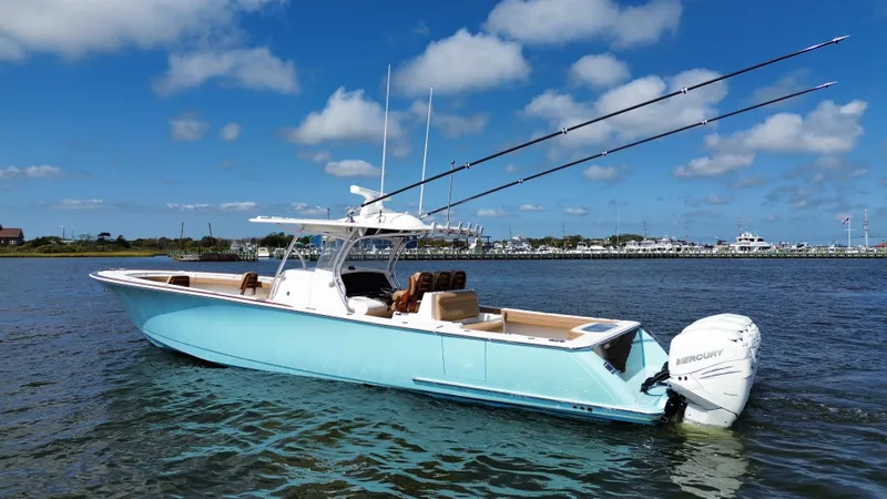 Slide: The Image of 2021 Valhalla Boatworks V-41 in blue on calm water, clear sky background. - 6