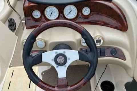 Slide: The Image of 2004 Glastron 185 GX boat dashboard with steering wheel and gauges. - 12