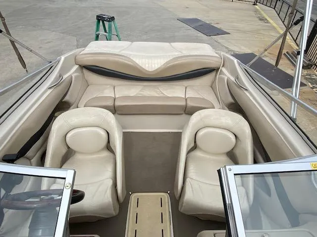 Slide: The Image of 2004 Glastron 185 GX boat interior with beige seating and open cockpit. - 5