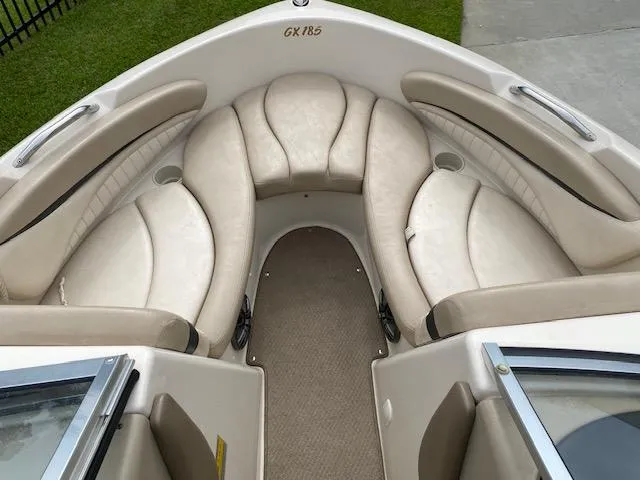 Slide: The Image of 2004 Glastron 185 GX boat interior with beige seating and carpeted floor. - 6