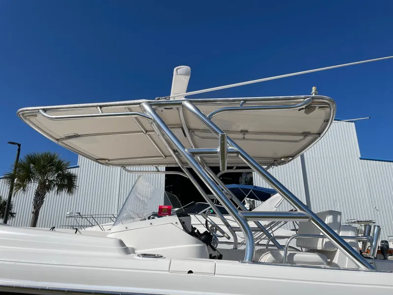 Slide: The Image of 2008 Intrepid 323 Cuddy boat with T-top against clear blue sky. - 15