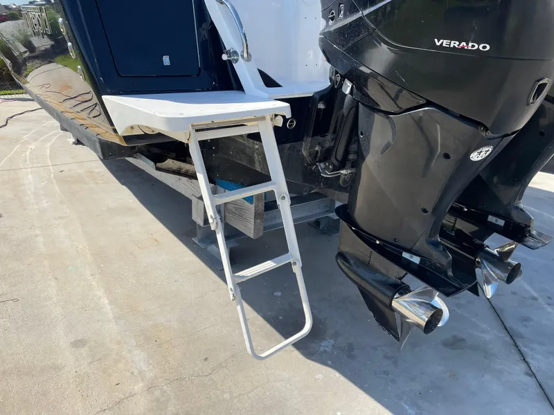 Slide: The Image of 2008 Intrepid 323 Cuddy with Verado engine and boarding ladder on a sunny day. - 16