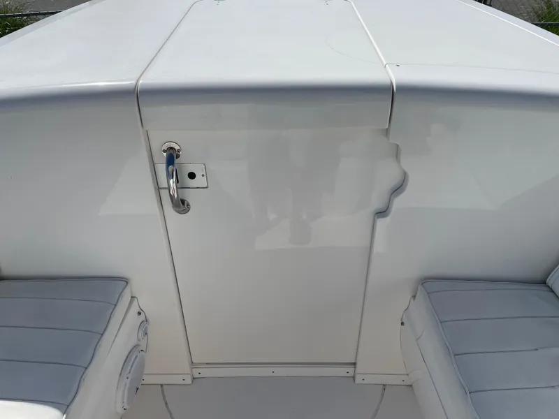 Slide: The Image of 2008 Intrepid 323 Cuddy boat interior with white seating and storage compartment. - 19