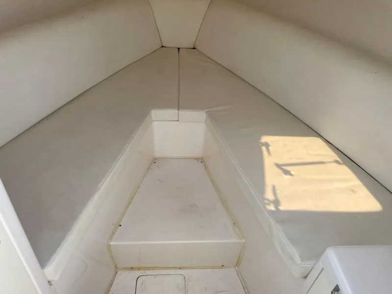 Slide: The Image of Interior of 2008 Intrepid 323 Cuddy boat with white cushioned seating. - 21
