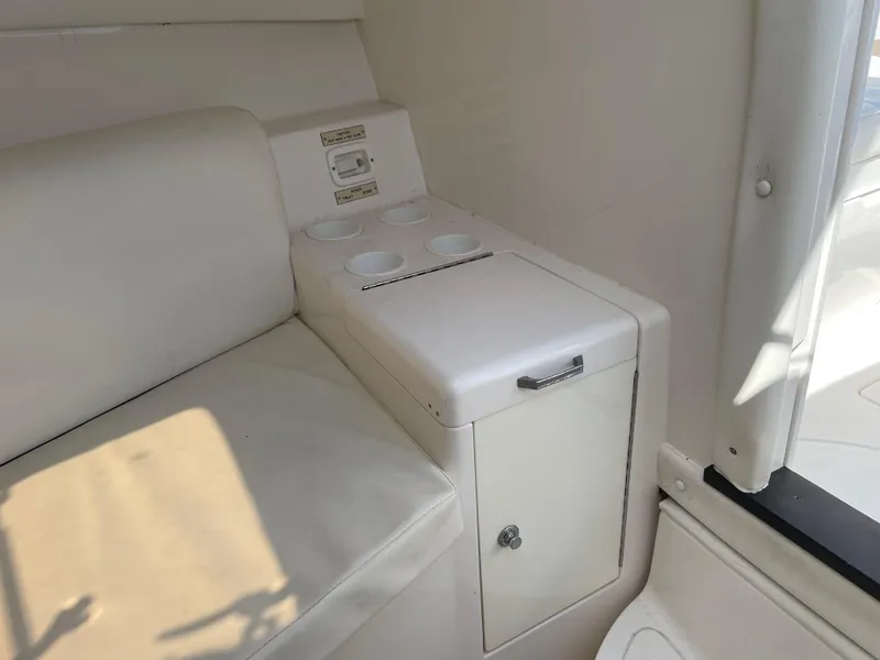 Slide: The Image of Interior of 2008 Intrepid 323 Cuddy with white seating and built-in cup holders. - 22