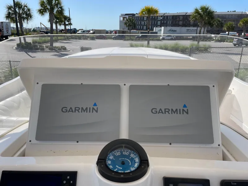 Slide: The Image of 2008 Intrepid 323 Cuddy dashboard with dual Garmin displays and compass. - 29