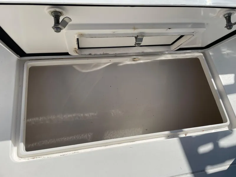 Slide: The Image of Open storage compartment on a 2008 Intrepid 323 Cuddy boat. - 45