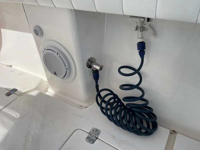 Slide: The Image of Coiled hose and speaker on 2008 Intrepid 323 Cuddy boat deck. - 48