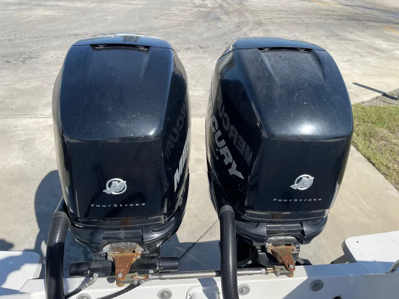 Slide: The Image of Twin Mercury outboard motors on a 2008 Intrepid 323 Cuddy boat. - 49