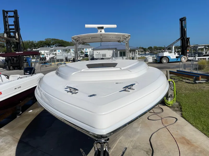 Slide: The Image of 2008 Intrepid 323 Cuddy boat in marina, front view, clear blue sky. - 5