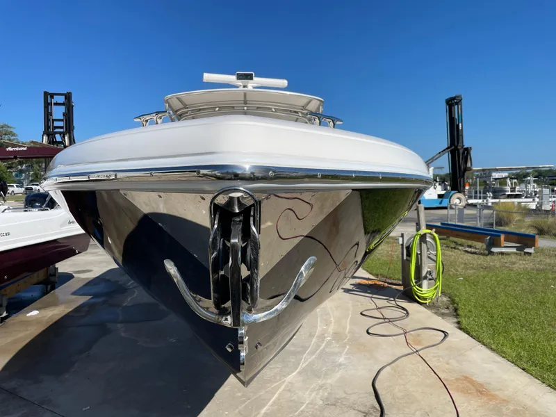 Slide: The Image of 2008 Intrepid 323 Cuddy boat on dry dock, front view, sunny day. - 6