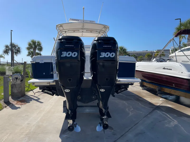 Slide: The Image of 2008 Intrepid 323 Cuddy with twin 300 horsepower engines, docked outdoors. - 7