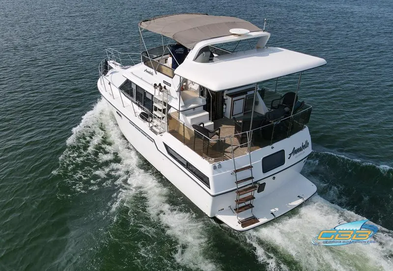 Slide: The Image of 1989 Carver 3807 Aft Cabin cruising on open water. - 13