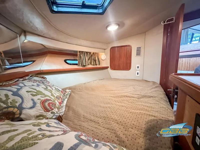 Slide: The Image of Cozy bedroom in 1989 Carver 3807 Aft Cabin yacht with skylight and patterned pillows. - 25