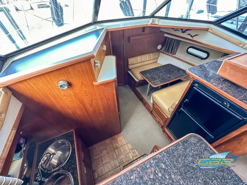 Slide: The Image of Interior of 1989 Carver 3807 Aft Cabin with kitchenette and seating area. - 33