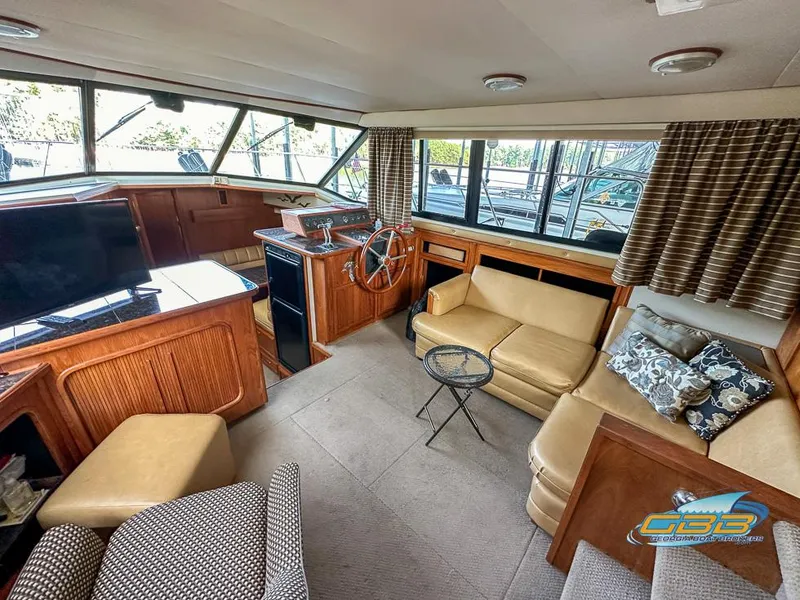 Slide: The Image of 1989 Carver 3807 Aft Cabin interior with cozy seating and helm station. - 39