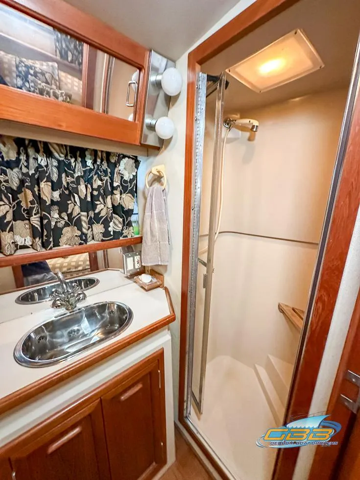 Slide: The Image of 1989 Carver 3807 Aft Cabin bathroom with shower and dual sinks. - 42