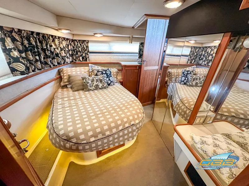 Slide: The Image of Luxurious 1989 Carver 3807 Aft Cabin bedroom with elegant decor and mirrored closet. - 43