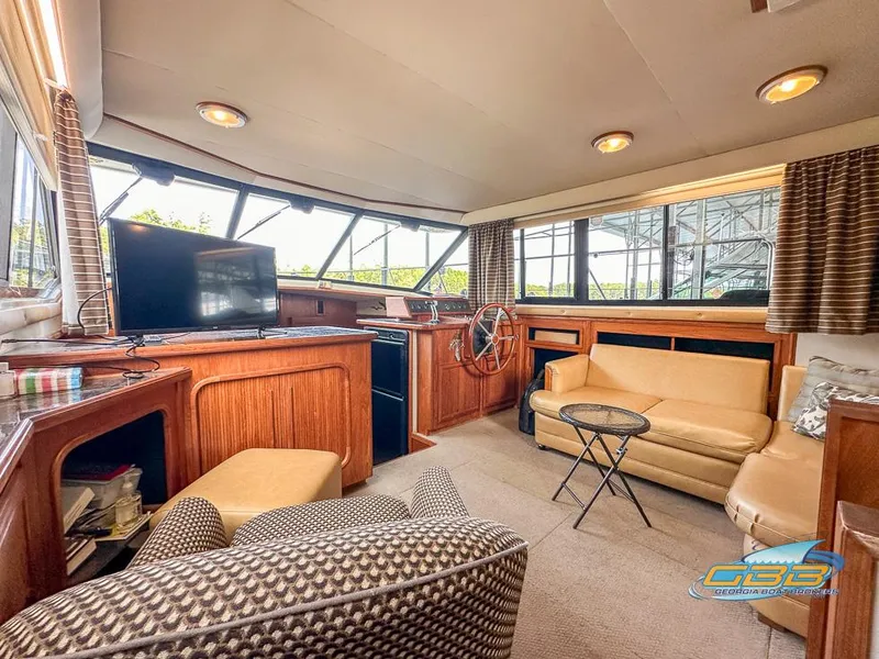 Slide: The Image of 1989 Carver 3807 Aft Cabin interior with seating, TV, and helm station. - 48