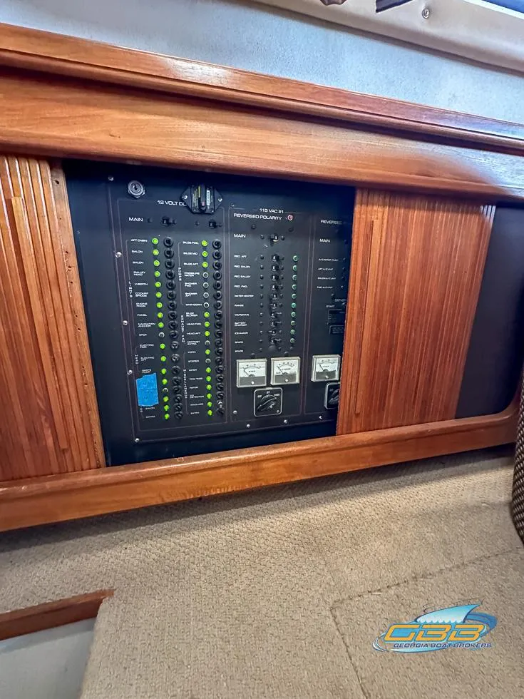 Slide: The Image of 1989 Carver 3807 Aft Cabin electrical panel with wooden trim. - 49