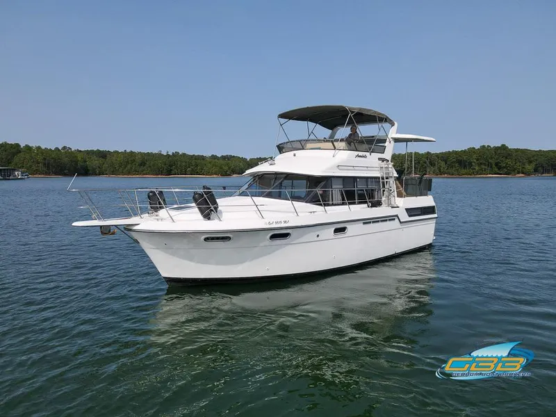Slide: The Image of 1989 Carver 3807 Aft Cabin yacht on calm water, clear sky background. - 6