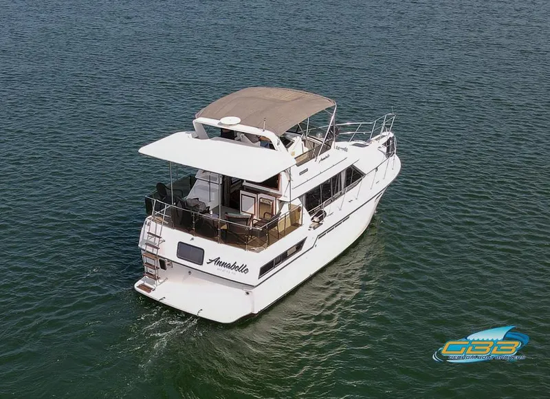 Slide: The Image of 1989 Carver 3807 Aft Cabin yacht cruising on open water. - 7