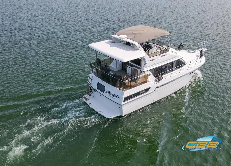 Slide: The Image of 1989 Carver 3807 Aft Cabin cruising on open water, aerial view. - 8