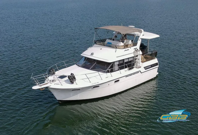The Image of 1989 Carver 3807 Aft Cabin yacht on calm water, aerial view. - 0