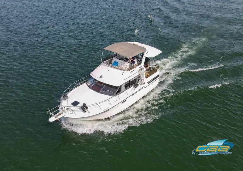 Slide: The Image of 1989 Carver 3807 Aft Cabin cruising on open water, aerial view. - 12