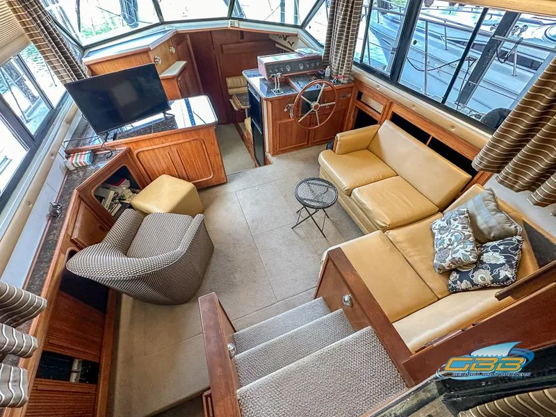 Slide: The Image of Interior of 1989 Carver 3807 Aft Cabin yacht with cozy seating and helm. - 17