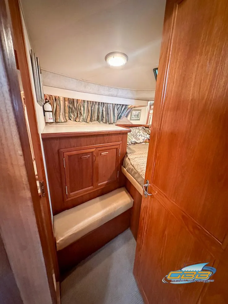 Slide: The Image of 1989 Carver 3807 Aft Cabin interior with wood paneling and cozy bed. - 22