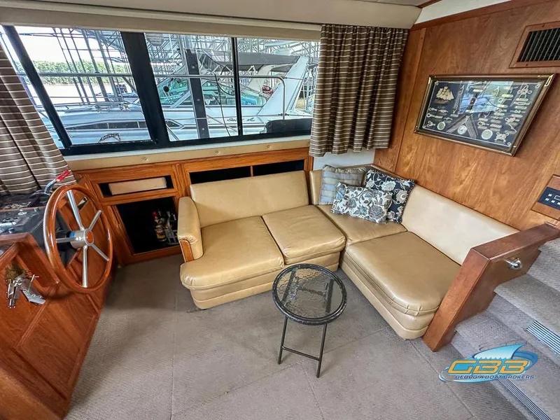 Slide: The Image of 1989 Carver 3807 Aft Cabin interior with beige seating and nautical decor. - 34