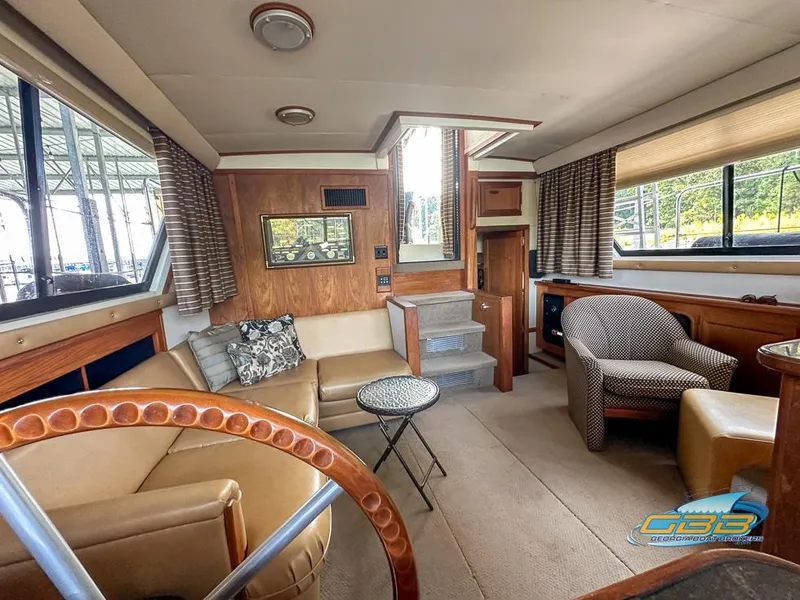 Slide: The Image of Interior of 1989 Carver 3807 Aft Cabin yacht with cozy seating and elegant decor. - 38