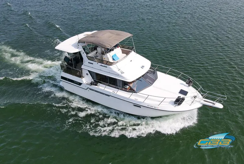 Slide: The Image of 1989 Carver 3807 Aft Cabin cruising on open water, aerial view. - 9