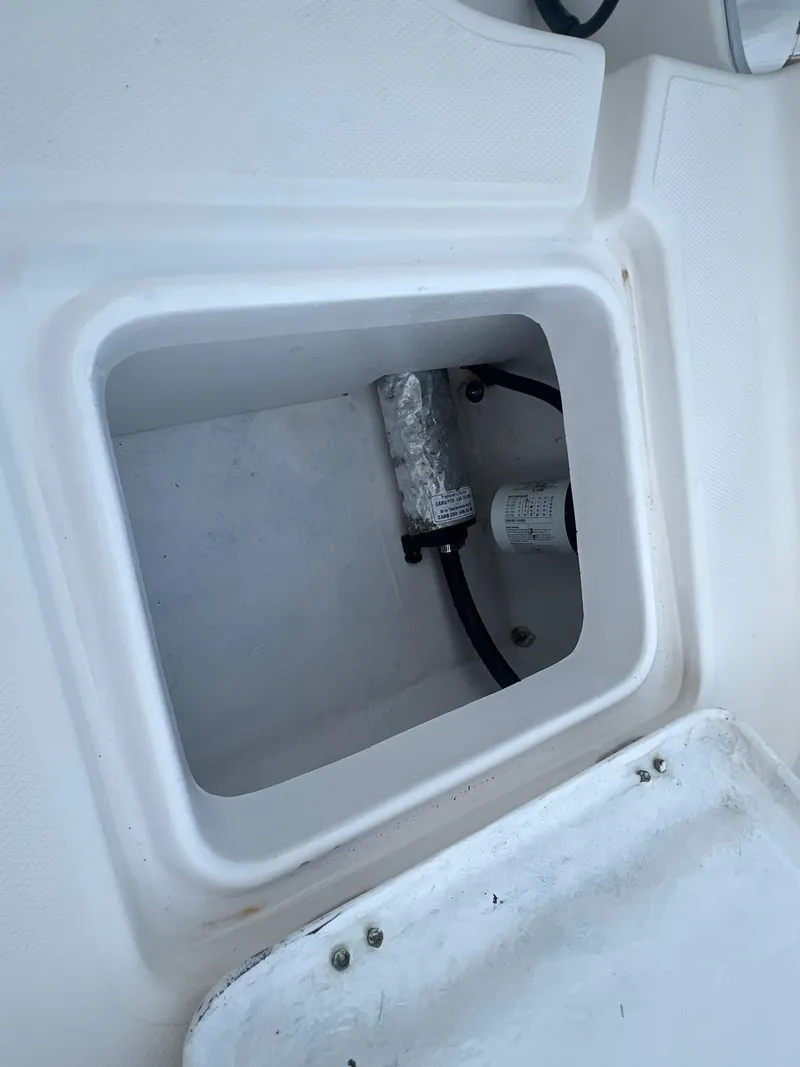 Slide: The Image of 2022 Clearwater 2100 Baystar boat compartment with wiring and components. - 10