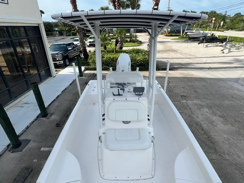 Slide: The Image of 2022 Clearwater 2100 Baystar boat with T-top, parked outdoors. - 14