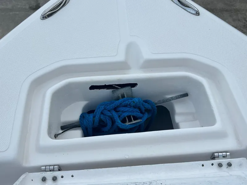 Slide: The Image of Clearwater 2100 Baystar 2022 boat anchor compartment with blue rope. - 16