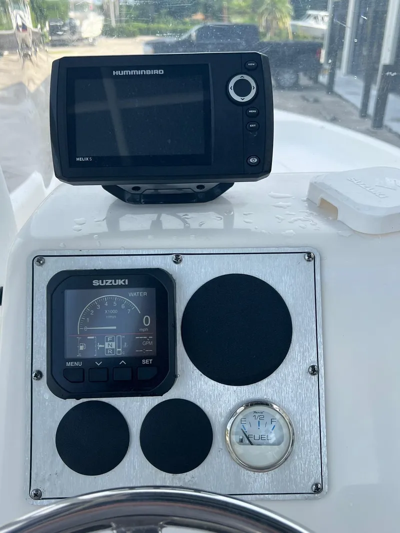 Slide: The Image of 2022 Clearwater 2100 Baystar boat dashboard with Humminbird and Suzuki displays. - 18