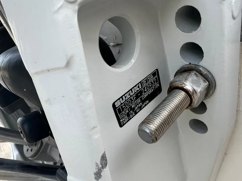 Slide: The Image of Close-up of a 2022 Clearwater 2100 Baystar boat engine bolt and Suzuki label. - 5