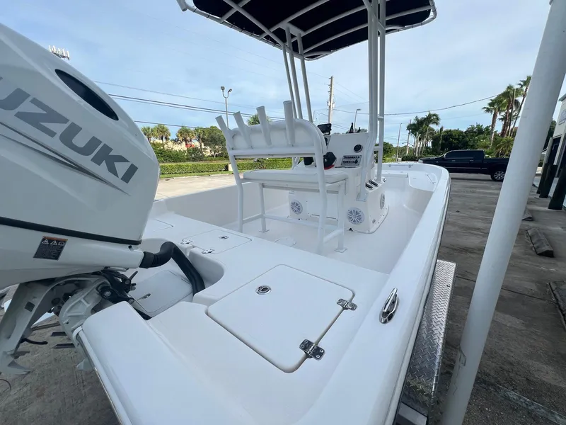 Slide: The Image of 2022 Clearwater 2100 Baystar boat with Suzuki engine, docked outdoors. - 6