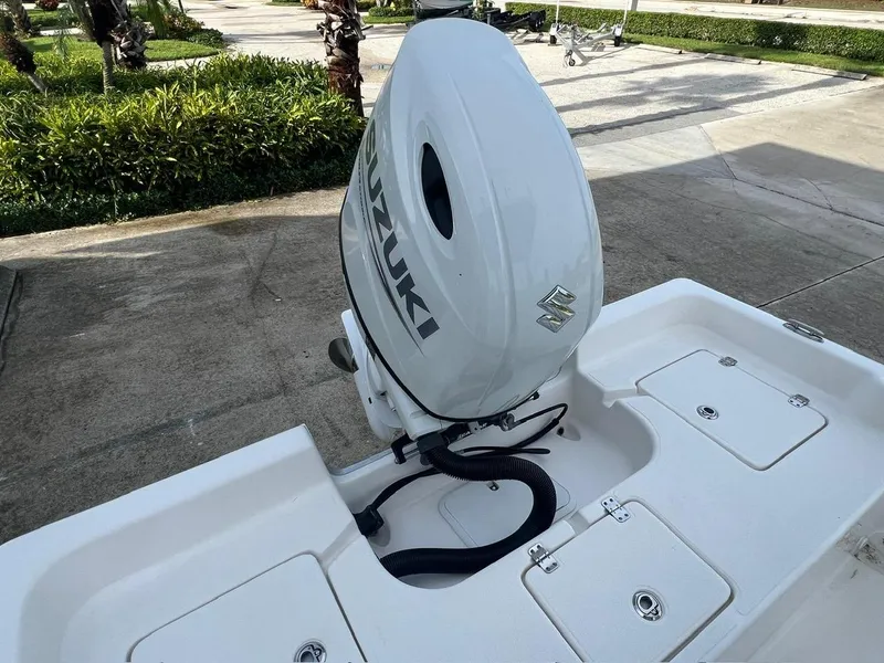 Slide: The Image of 2022 Clearwater 2100 Baystar boat with Suzuki outboard motor in a driveway. - 8