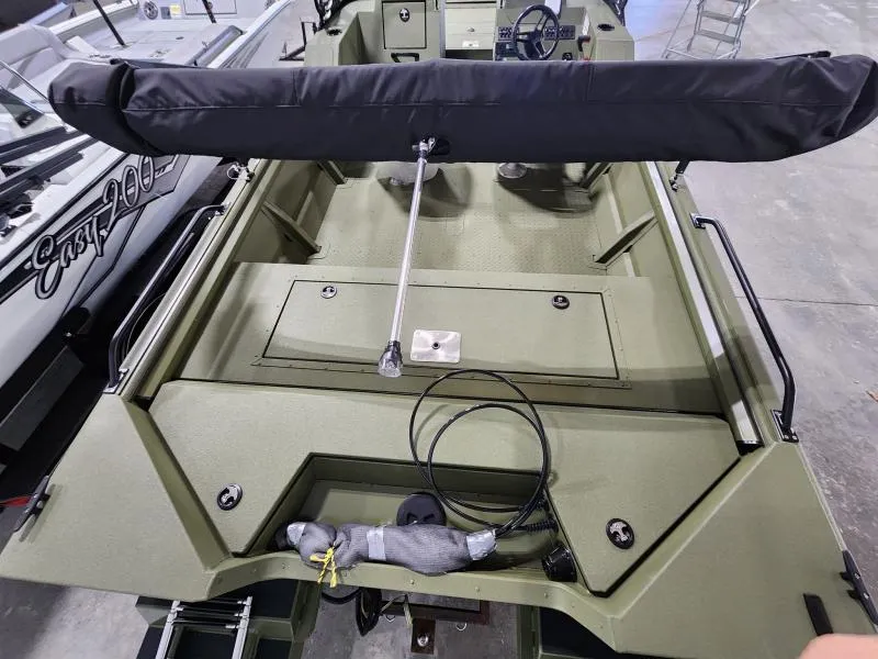 Slide: The Image of 2025 SeaArk Protege boat interior with covered seating and storage compartments. - 3