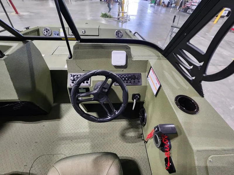 Slide: The Image of 2025 SeaArk Protege boat interior with steering wheel and control panel. - 6