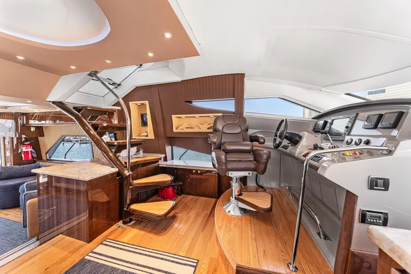 Slide: The Image of Luxurious interior of a 2007 Marquis 55 LS yacht with modern helm and seating. - 11