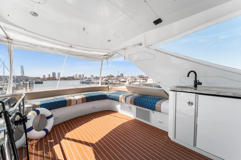 Slide: The Image of Luxurious 2007 Marquis 55 LS yacht deck with seating, city skyline view, and onboard amenities. - 22